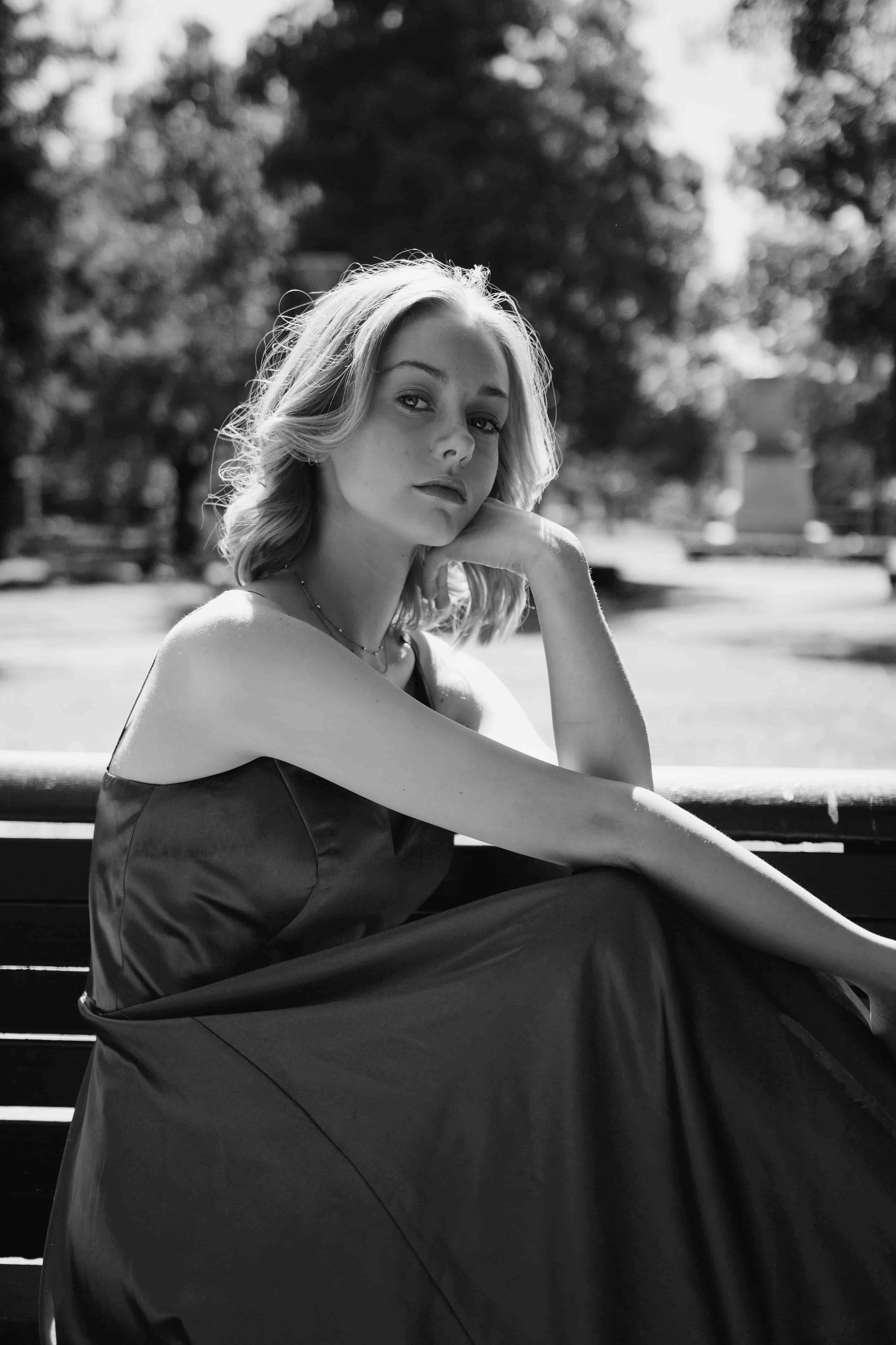 woman in gray dress sitting on stairs